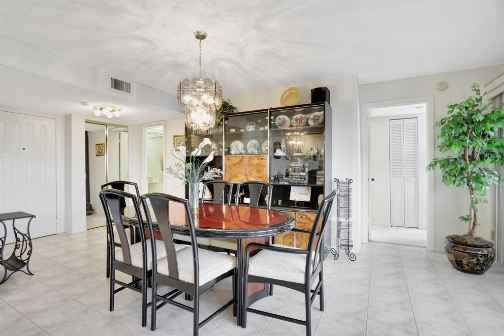 330 Southeast 20th Avenue, Unit 307 Deerfield Beach, FL 33441 - Photo 23 of 48 a dining room with furniture and chandelier