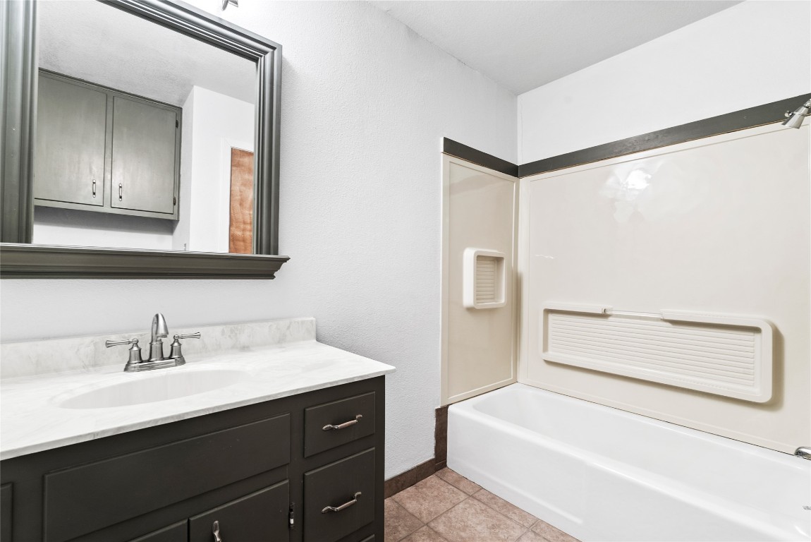 12914 Pfluger Berkman Road Coupland, TX 78615 - Photo 17 of 39 a bathroom with a sink and a mirror