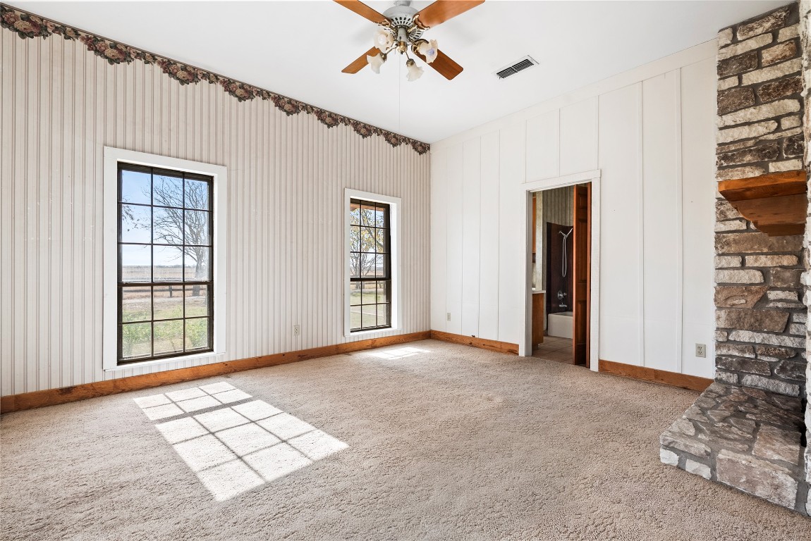 12914 Pfluger Berkman Road Coupland, TX 78615 - Photo 20 of 39 an empty room with windows and ceiling fan
