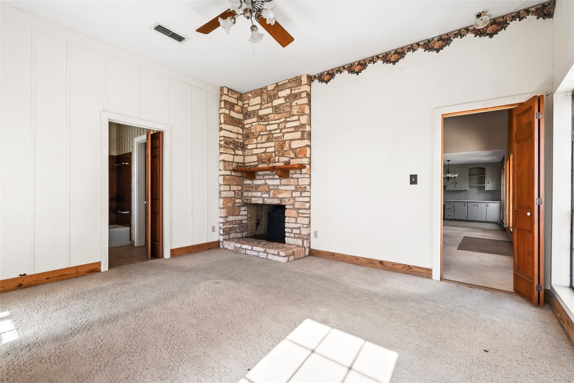 12914 Pfluger Berkman Road Coupland, TX 78615 - Photo 21 of 39 a view of an empty room with a fireplace and a window