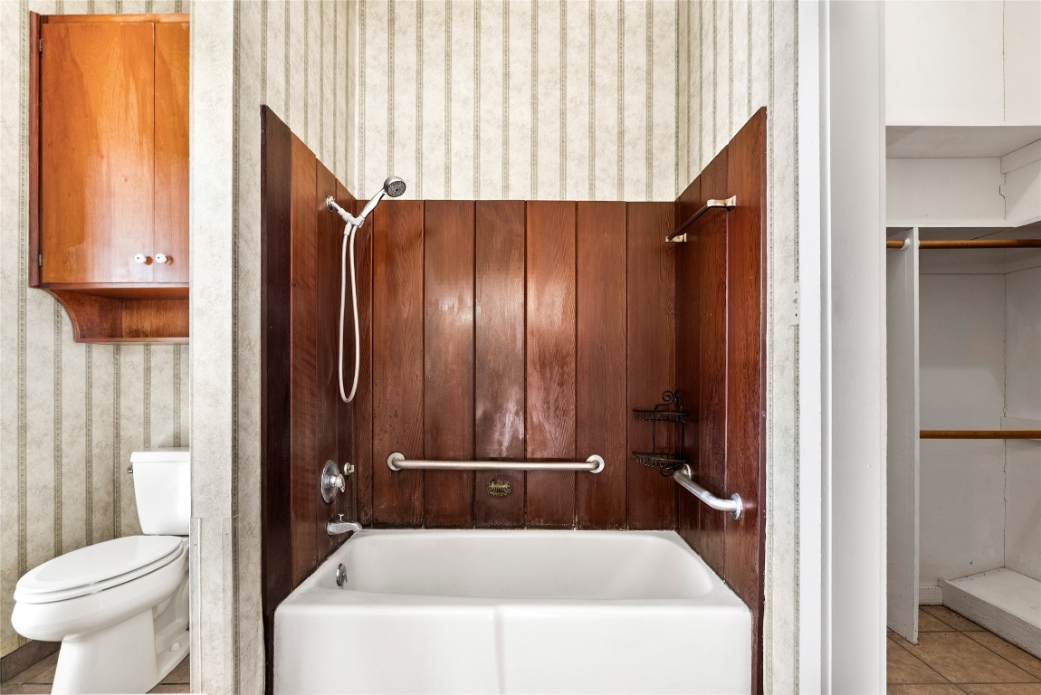 12914 Pfluger Berkman Road Coupland, TX 78615 - Photo 22 of 39 a bathroom with a sink a toilet and shower curtain