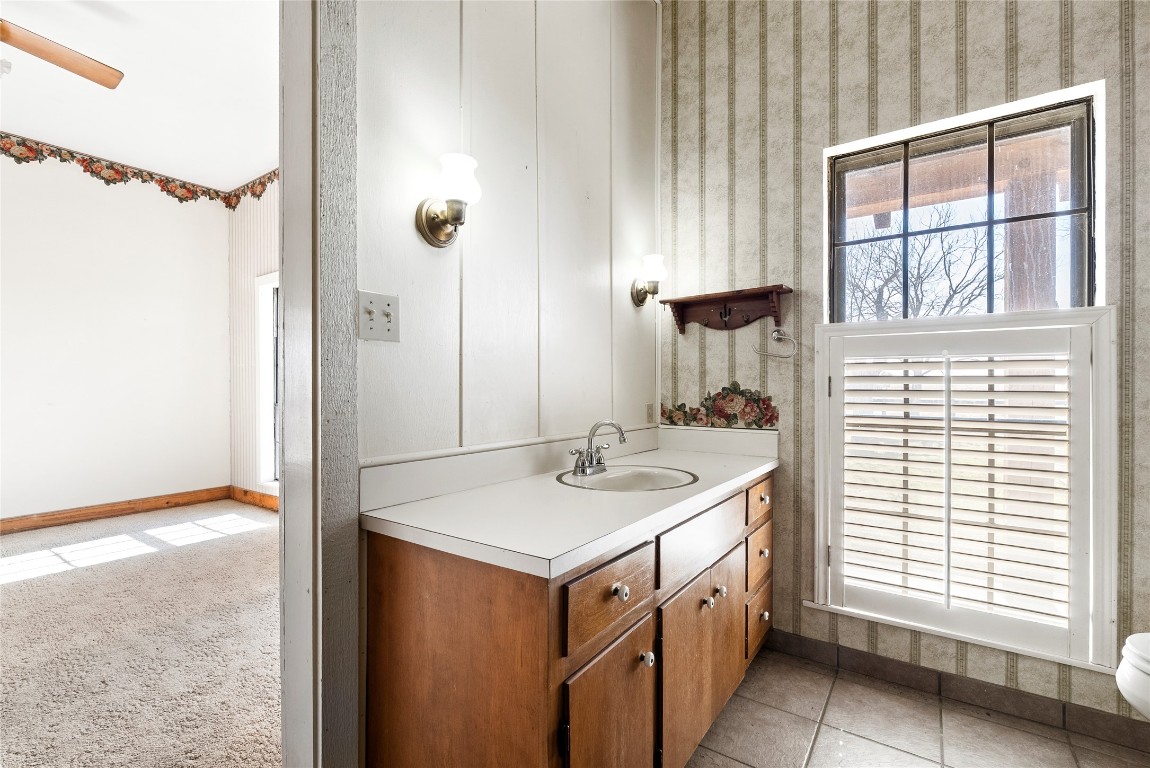 12914 Pfluger Berkman Road Coupland, TX 78615 - Photo 23 of 39 a bathroom with a sink a vanity and a mirror