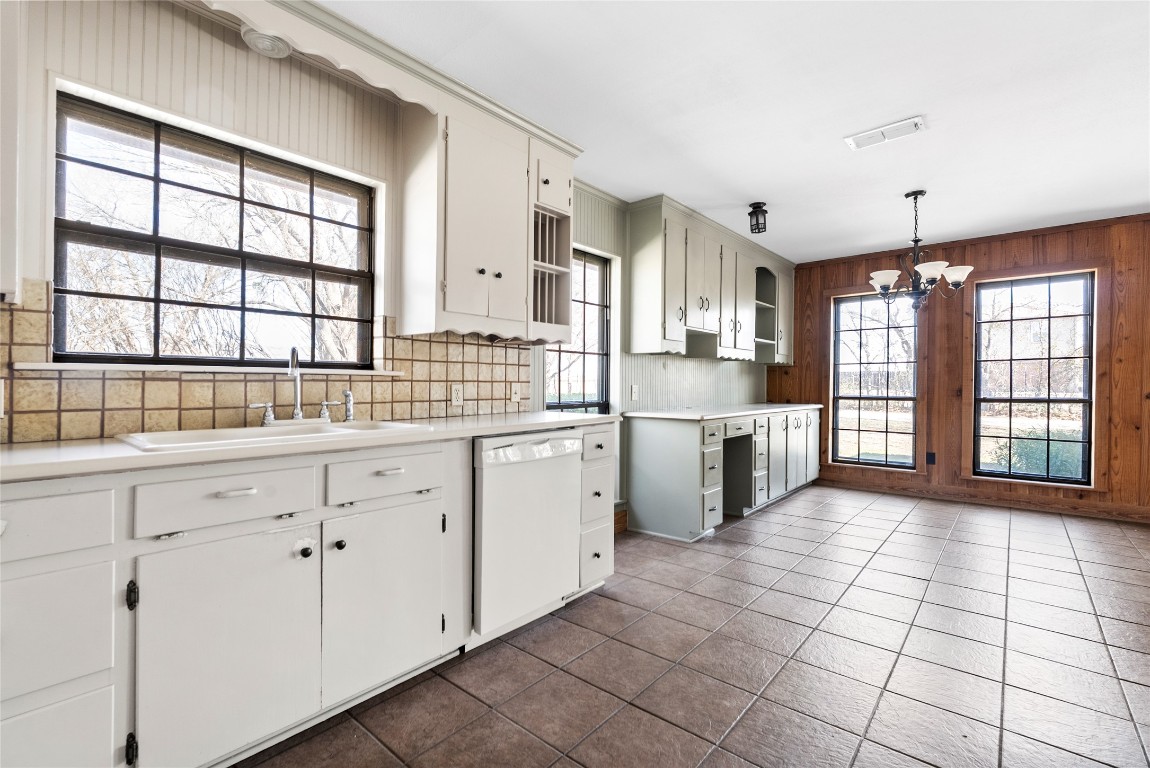 12914 Pfluger Berkman Road Coupland, TX 78615 - Photo 29 of 39 a large white kitchen with granite countertop a stove a sink a window and stainless steel appliances