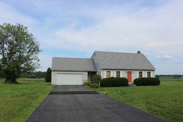 500 Hadley Road Sunderland, MA 01375 - Photo 1 of 22 a front view of a house with a yard and garage