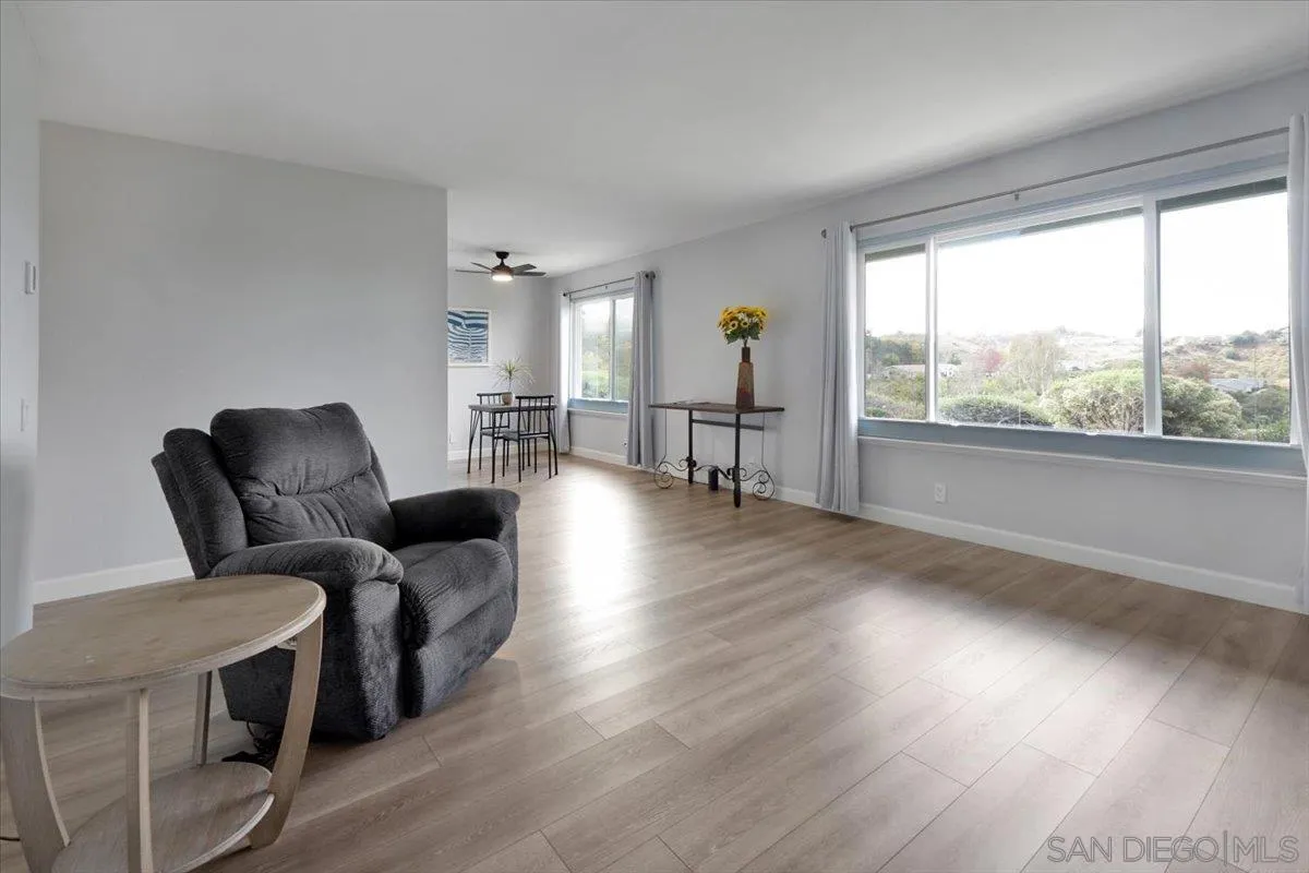 4436 Skimmer Way Oceanside, CA 92057 - Photo 11 of 71 a living room with furniture and a wooden floor