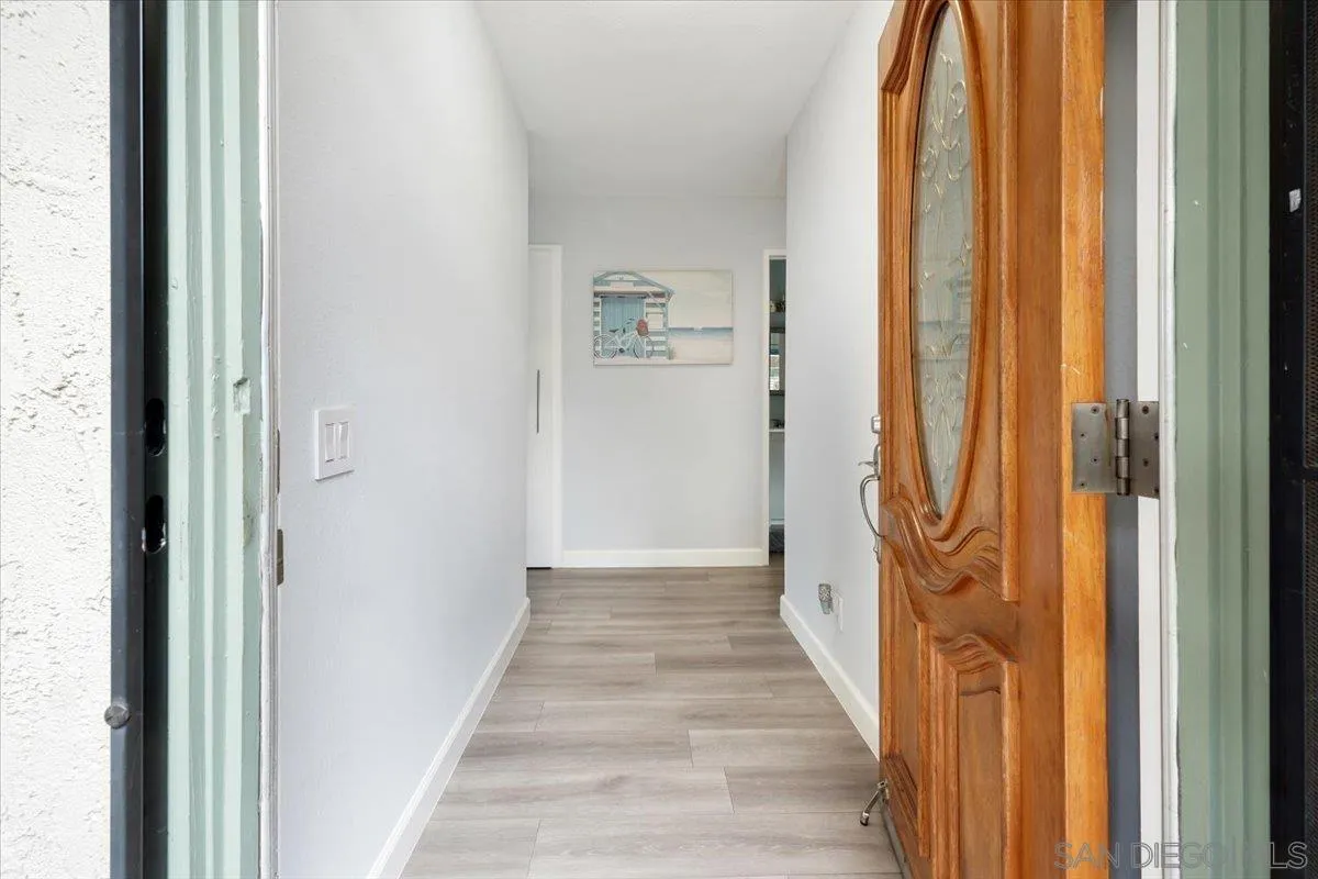 4436 Skimmer Way Oceanside, CA 92057 - Photo 19 of 71 a view of a hallway with wooden floor and glass door