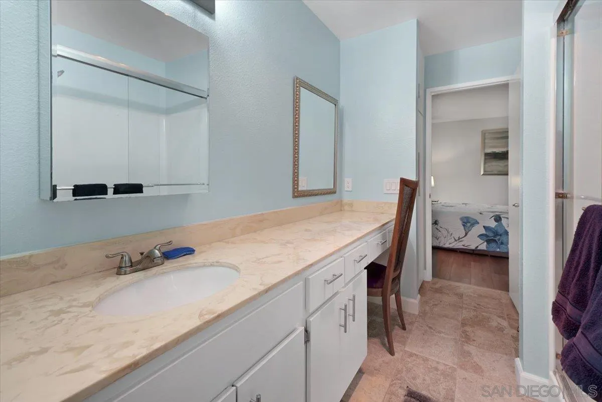 4436 Skimmer Way Oceanside, CA 92057 - Photo 22 of 71 a en suite bathroom with a granite countertop sink and a mirror