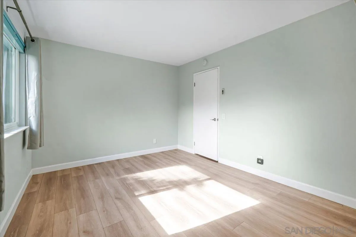 4436 Skimmer Way Oceanside, CA 92057 - Photo 25 of 71 an empty room with wooden floor and windows