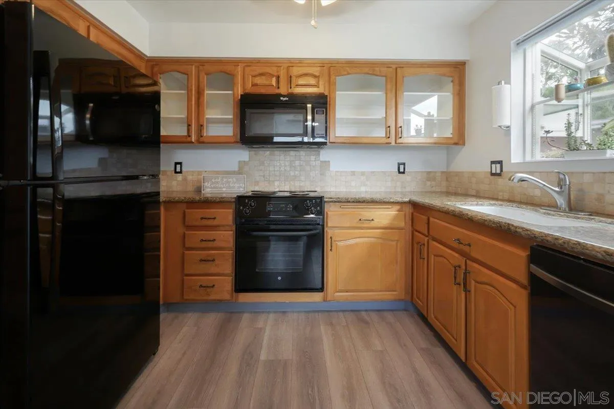 4436 Skimmer Way Oceanside, CA 92057 - Photo 5 of 71 a kitchen with stainless steel appliances granite countertop a stove a sink and a microwave
