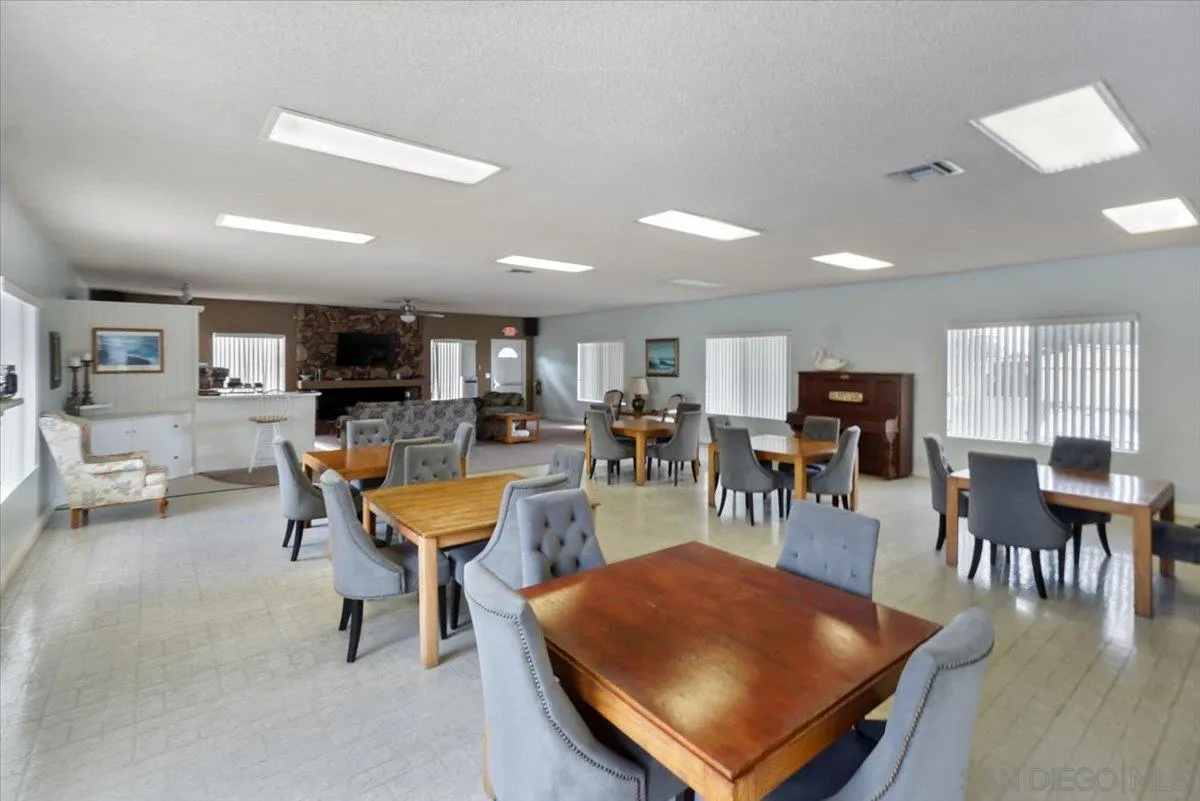 4436 Skimmer Way Oceanside, CA 92057 - Photo 55 of 71 a living room with furniture a flat screen tv and a kitchen view