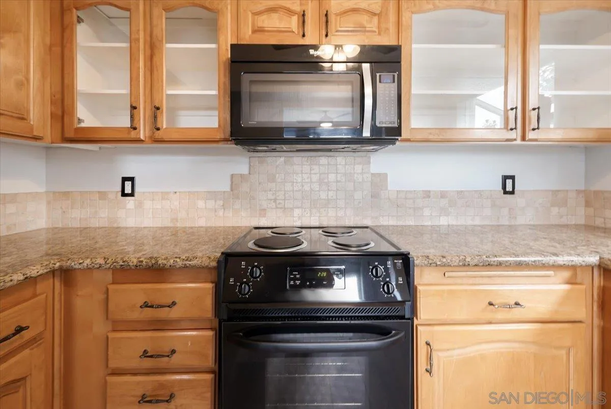 4436 Skimmer Way Oceanside, CA 92057 - Photo 6 of 71 a kitchen with stainless steel appliances granite countertop a stove and a microwave