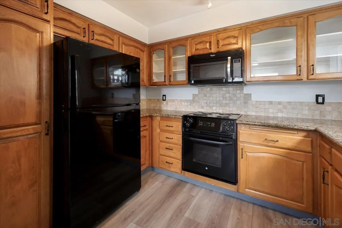 4436 Skimmer Way Oceanside, CA 92057 - Photo 9 of 71 a kitchen with stainless steel appliances granite countertop a stove microwave and refrigerator
