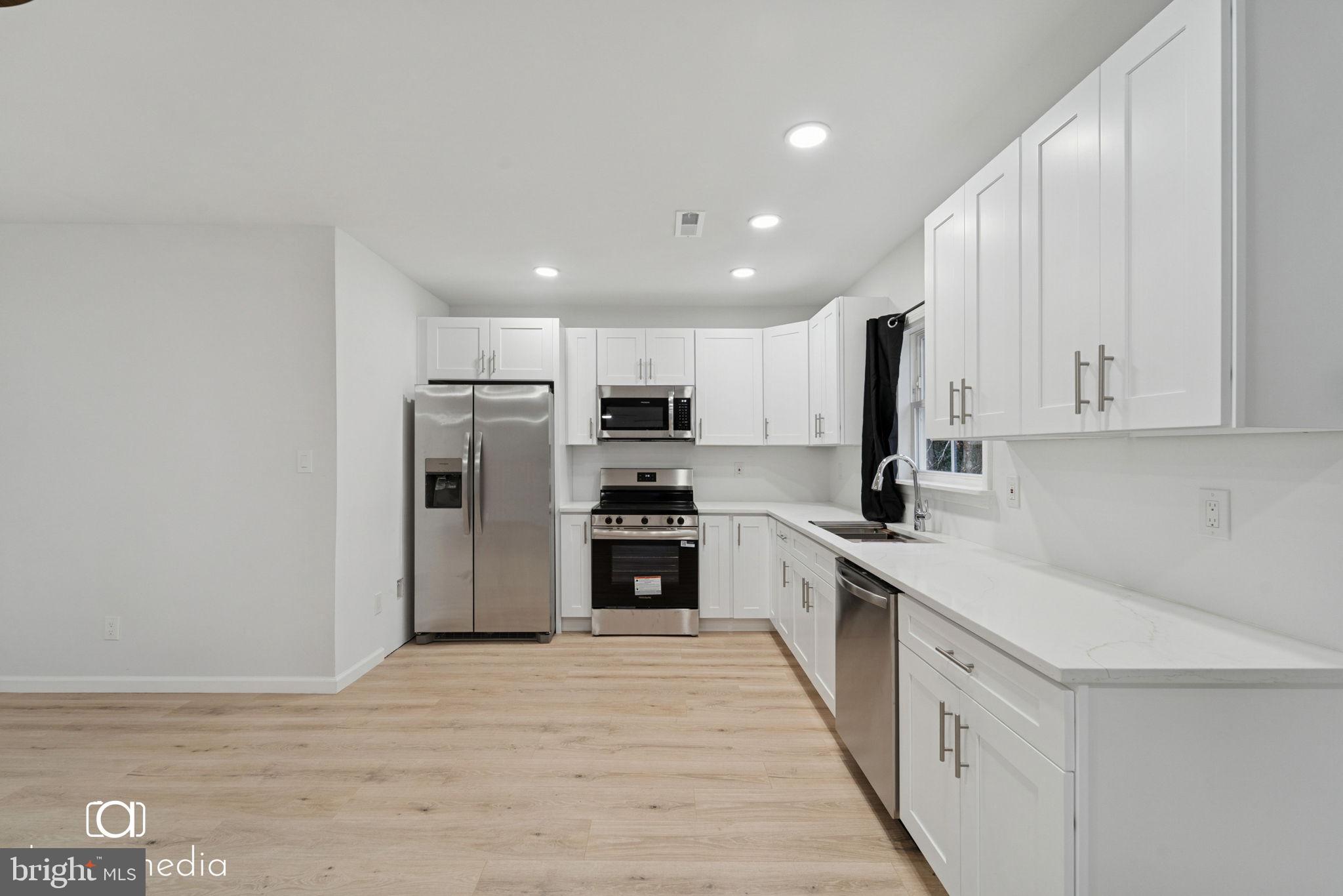 303 Gooseberry Road Millville, NJ 08332 - Photo 3 of 22 a kitchen with stainless steel appliances granite countertop a refrigerator and a stove top oven