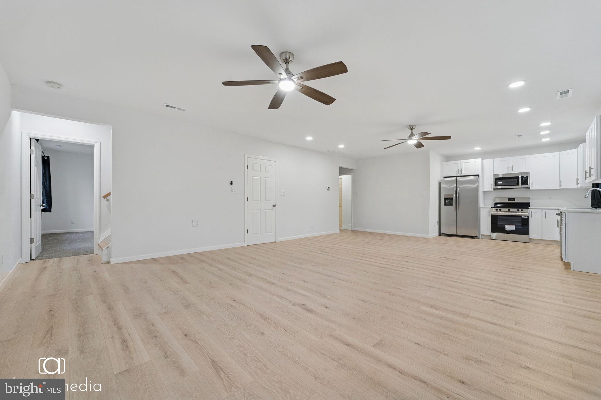 303 Gooseberry Road Millville, NJ 08332 - Photo 7 of 22 a view of empty room with wooden floor and ceiling fan