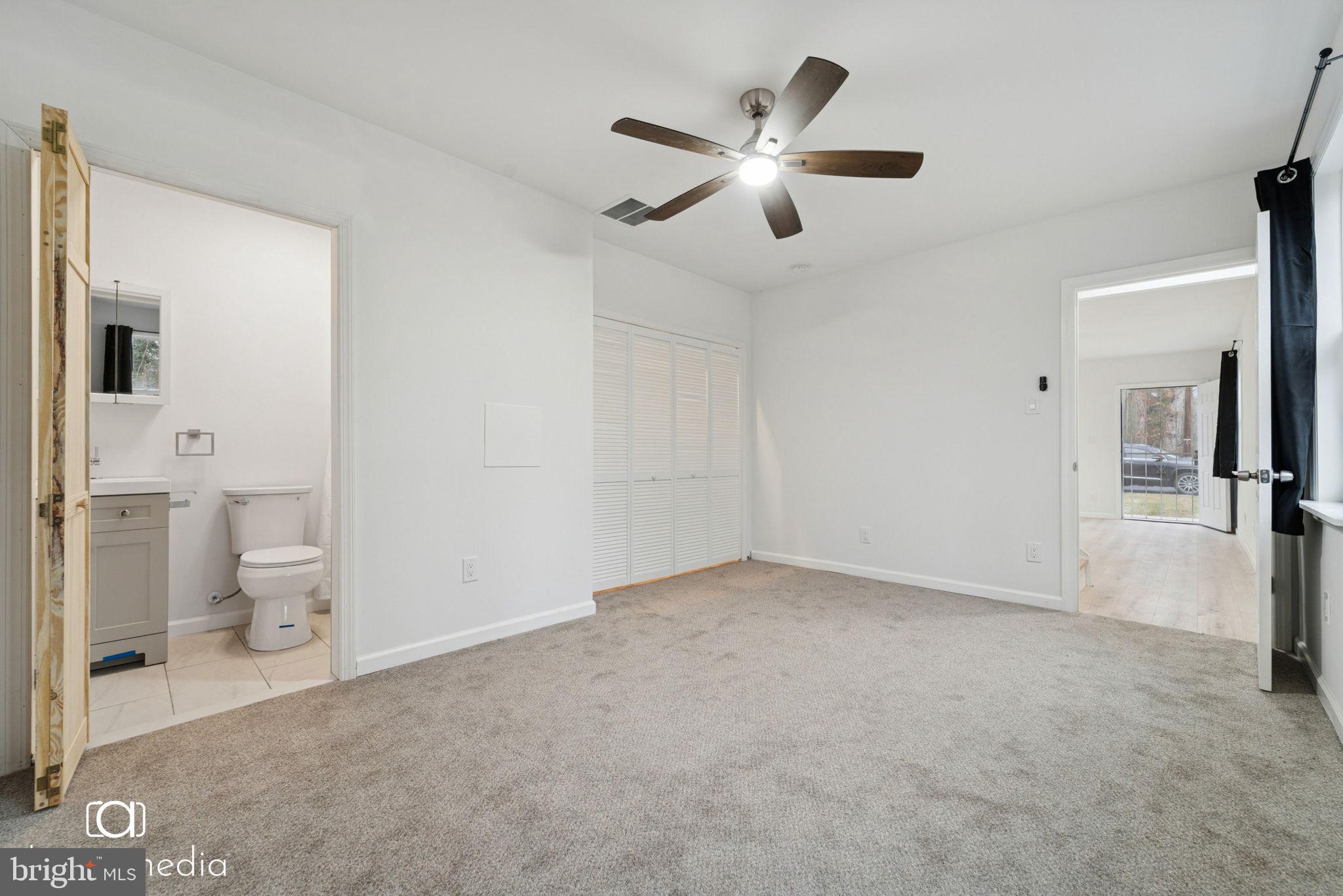 303 Gooseberry Road Millville, NJ 08332 - Photo 8 of 22 wooden floor in an empty room and a bathroom