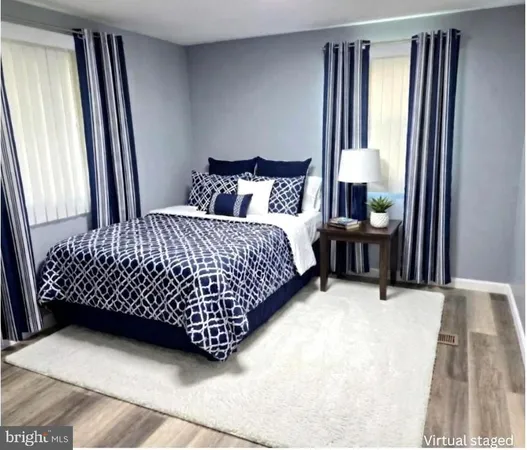 a bed sitting in a bedroom next to a window