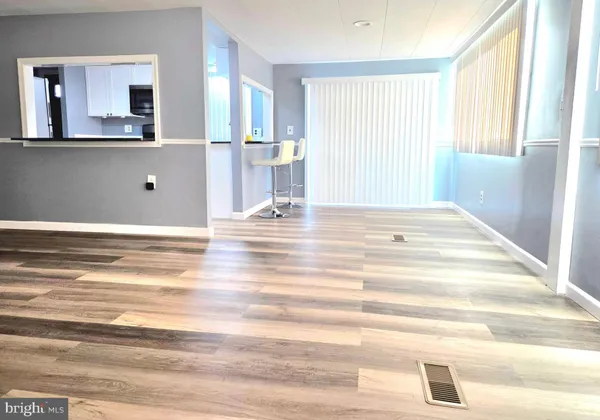 a view of a room that has a bed and a window in it