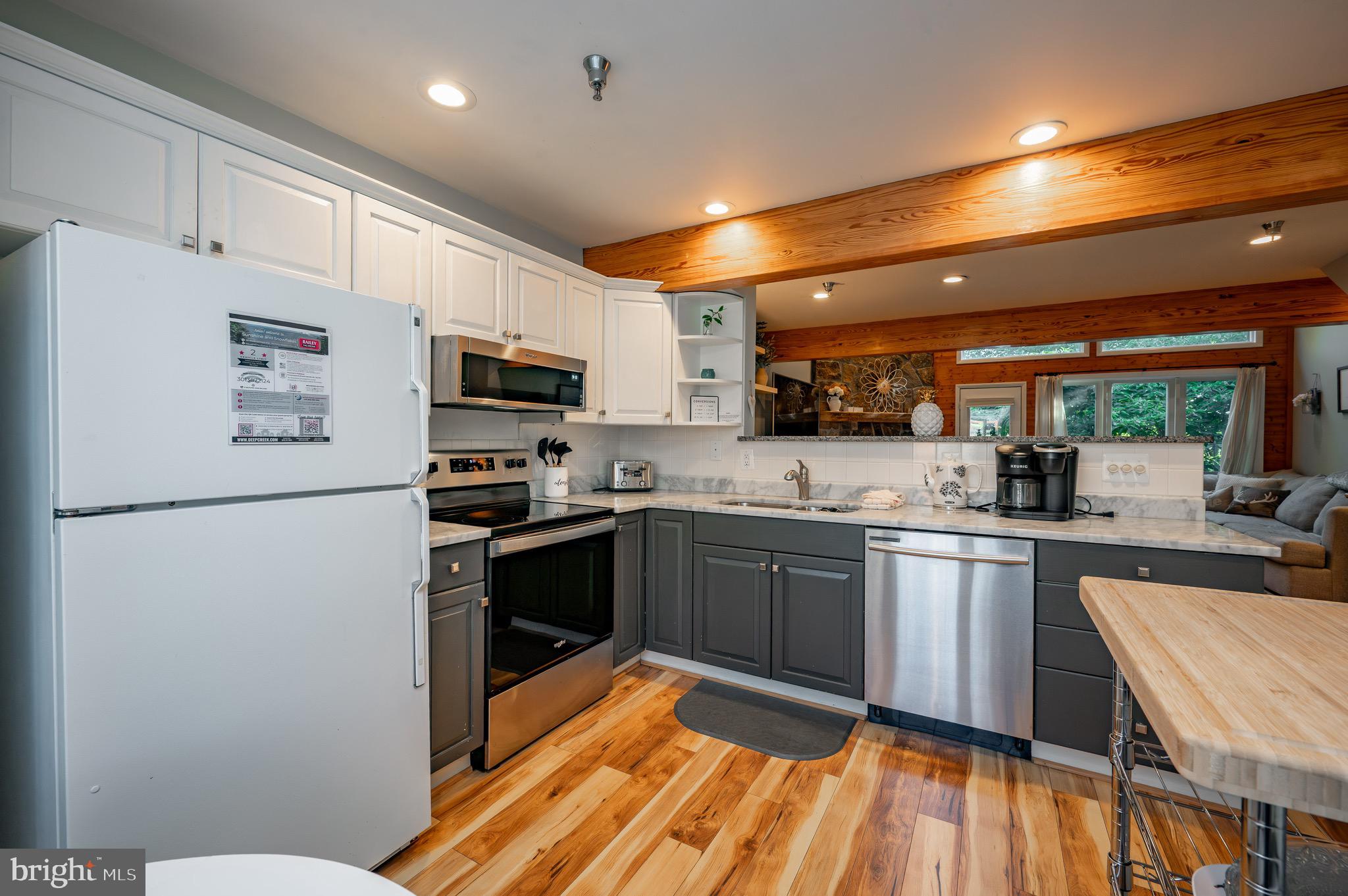 257 Marsh Hill Road, Unit 44 McHenry, MD 21541 - Photo 11 of 50 a kitchen with a sink stainless steel appliances and white cabinets