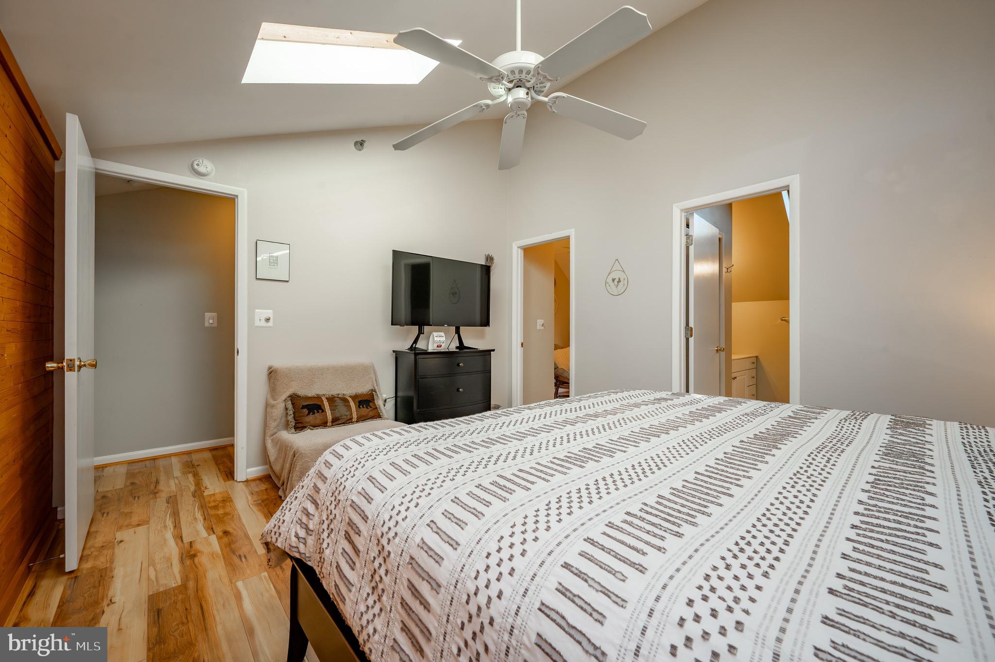 257 Marsh Hill Road, Unit 44 McHenry, MD 21541 - Photo 30 of 50 a bedroom with a bed and a flat tv screen on dresser