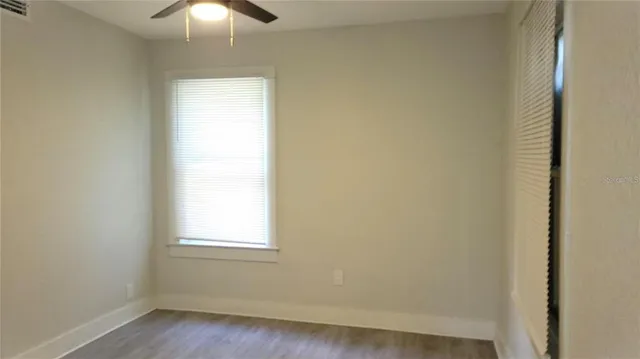 a bed sitting in a bathroom next to a window