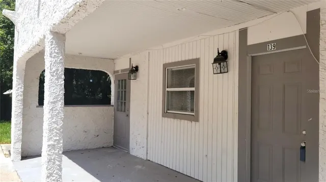 a bathroom with a sink mirror and a window