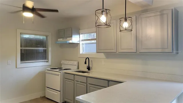 a kitchen with a sink cabinets and appliances