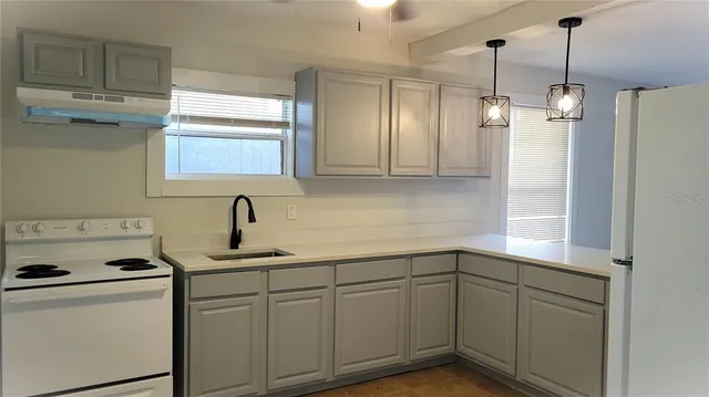 a kitchen with a sink and cabinets