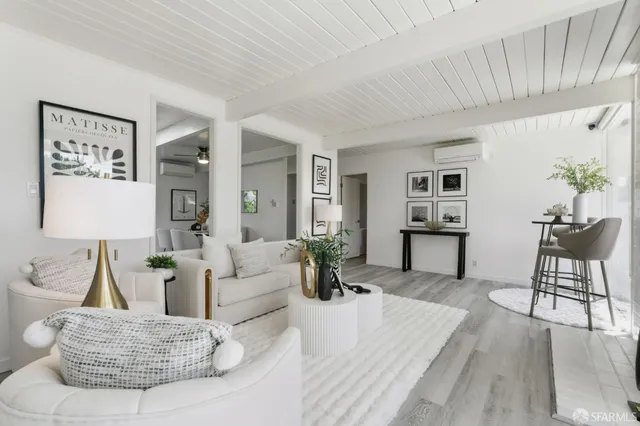 a living room with a fireplace and a large window