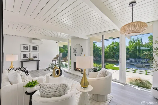 a kitchen with kitchen island stainless steel appliances a dining table and chairs