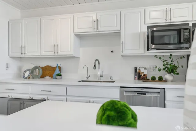 a spacious bedroom with a bed and a potted plant