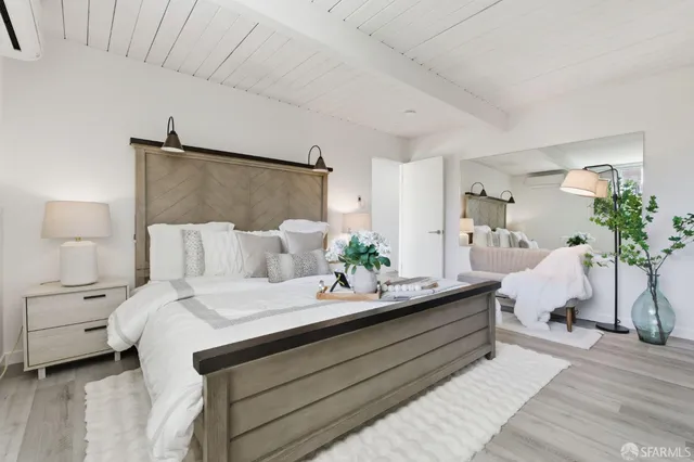 a bedroom with a bed and a potted plant