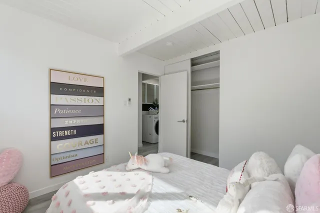 a bedroom with bed and a window