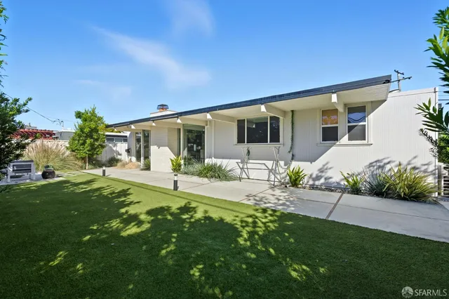 a view of backyard with sitting area