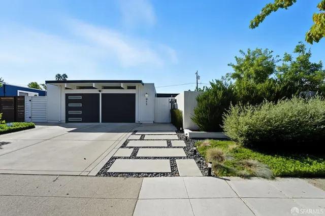 a front view of a house with a garden