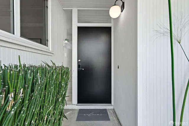 a view of a patio with table and chairs potted plants