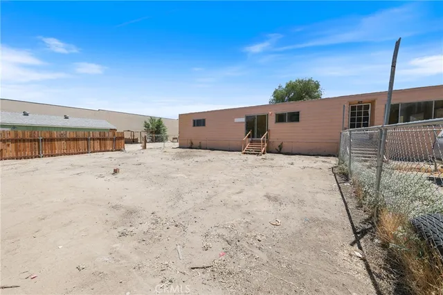 a view of a dry yard with trees