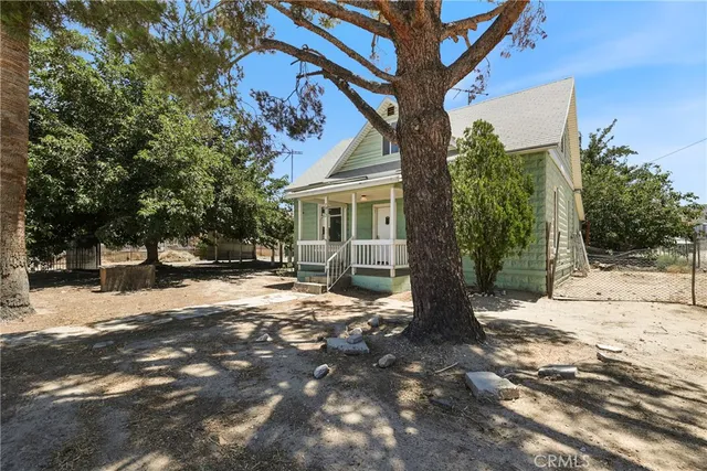 a view of a house with a tree in front