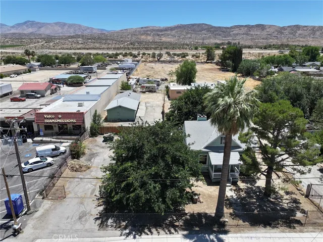 an aerial view of residential houses with outdoor space and seating