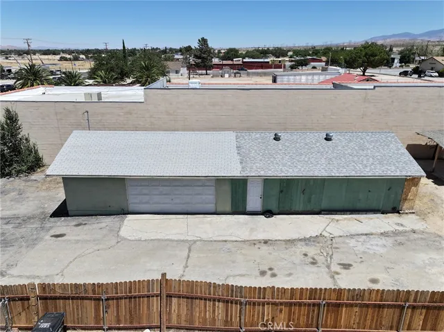 an aerial view of a house with a yard basket ball court and outdoor seating