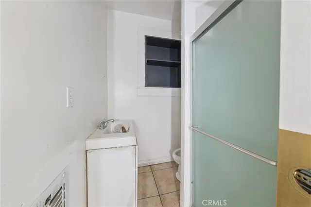 a bathroom with a sink toilet and mirror