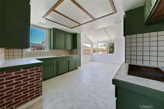 a kitchen with a sink and a stove top oven
