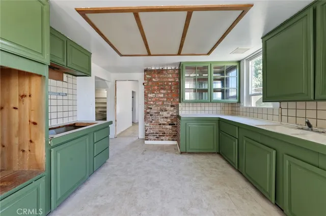 a kitchen with window and cabinets