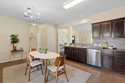 a large kitchen with a table and chairs