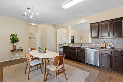a large kitchen with a table and chairs