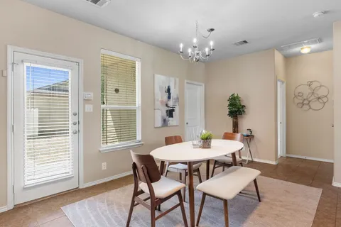 a view of a dining room with furniture and window