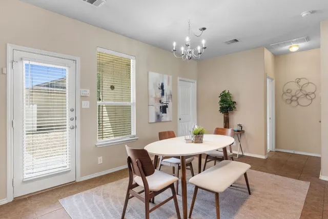 a view of a dining room with furniture and window