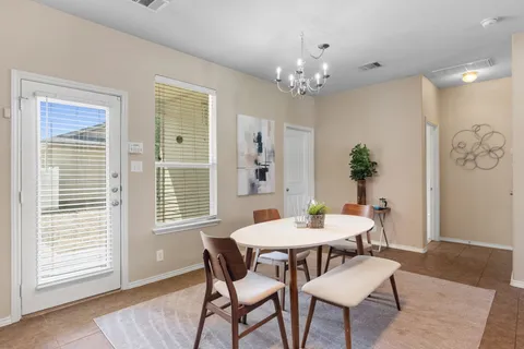 a view of a dining room with furniture and window