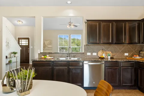 a kitchen with stainless steel appliances granite countertop a stove a sink dishwasher a microwave oven with granite countertops and cabinets