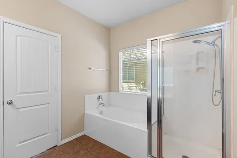 a bathroom with a bathtub and a shower