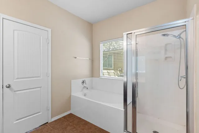 a bathroom with a bathtub and a shower